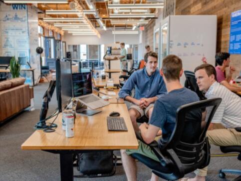 People talking around a desk.